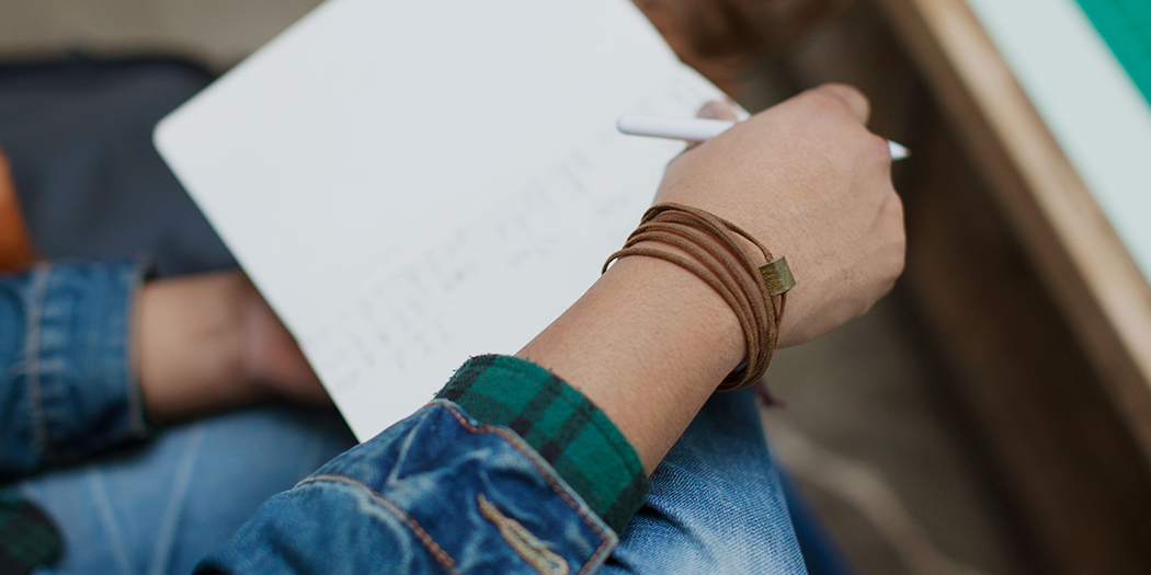 Wood bracelet worn by customer. Verawood with brown cotton cord wrap.