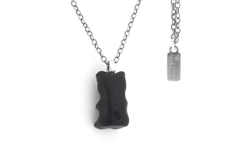 Back of Bear pendant showing Omerica logo. Ebony wood pendant with sterling silver bail.