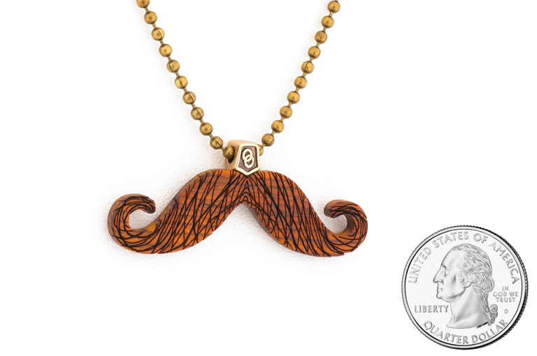Mustache pendant. Made in Cocobolo wood with bronze hardware. Size scale.