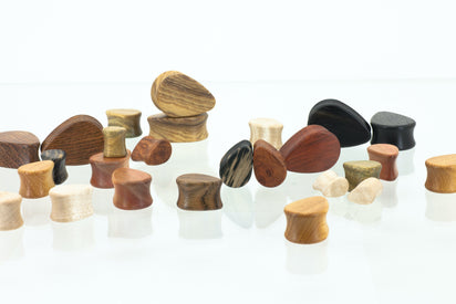 Ear gauges, teardrop shaped made in different woods. 