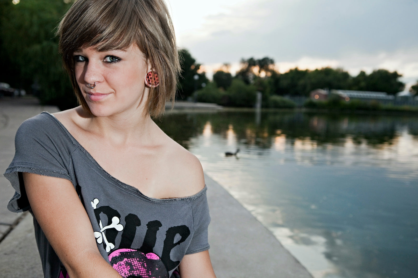 Women modeling Baroque style ear gauges outdoors. 