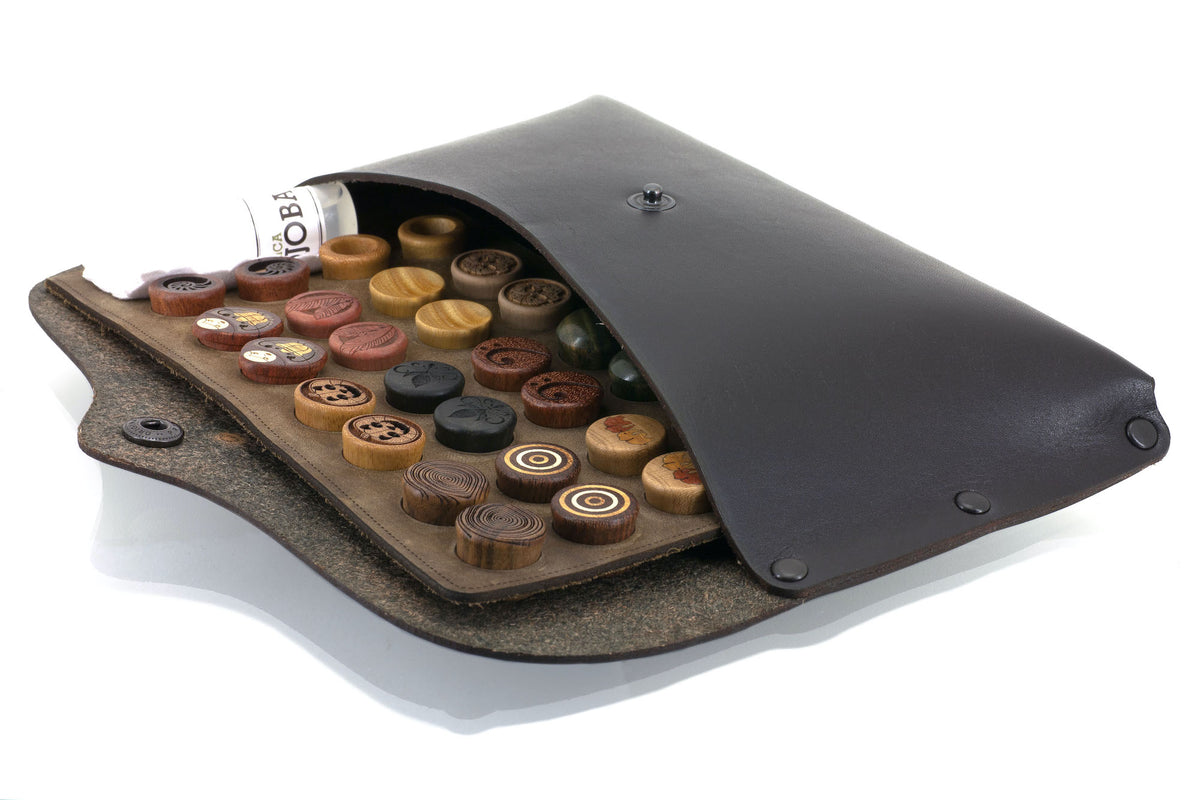 Omerica black leather pouch holding custom ear gauges.