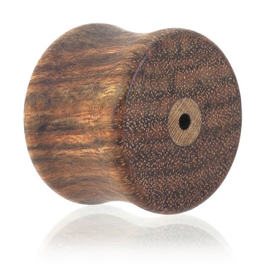 Closeup of Stud Earring Gauge Plugs made in Chechen wood. 