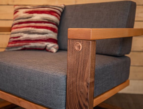 Chair with custom wood logo inserted on arm. 