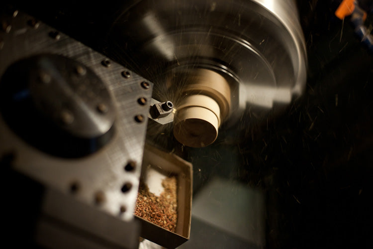 CNC lathe carving a wood ear gauge plug.  