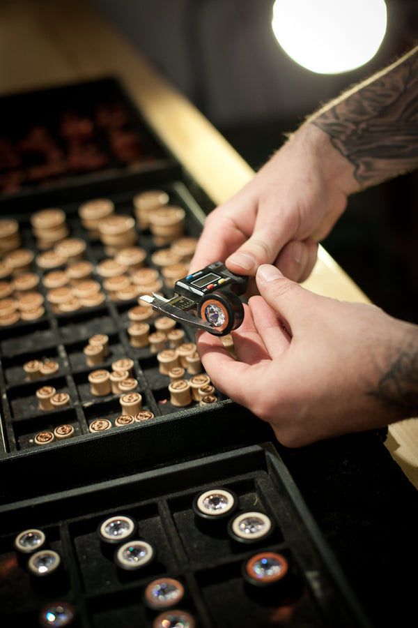 Measuring ear gauges during quality inspection. 