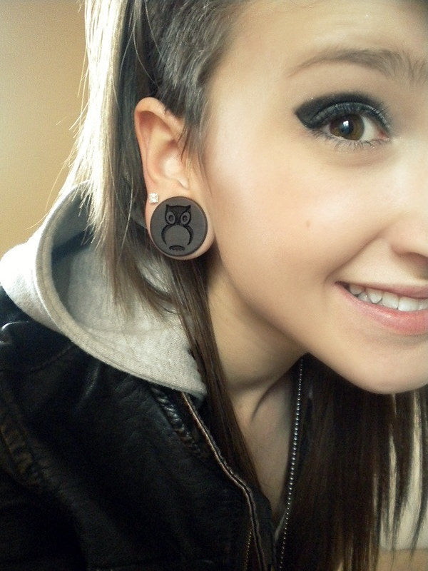 Customer wearing Owl Plugs wood ear gauges. 