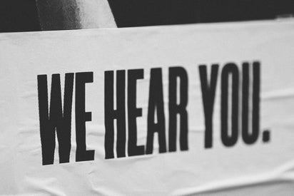 White banner with black text We Hear You. 