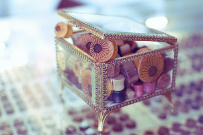 Glass jewelry box filled with Omerica wood ear gauges. 