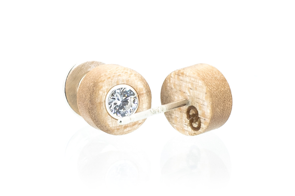 Wood earrings set with Swarovski CZ. Wood is Curly Maple. View of back logo.  