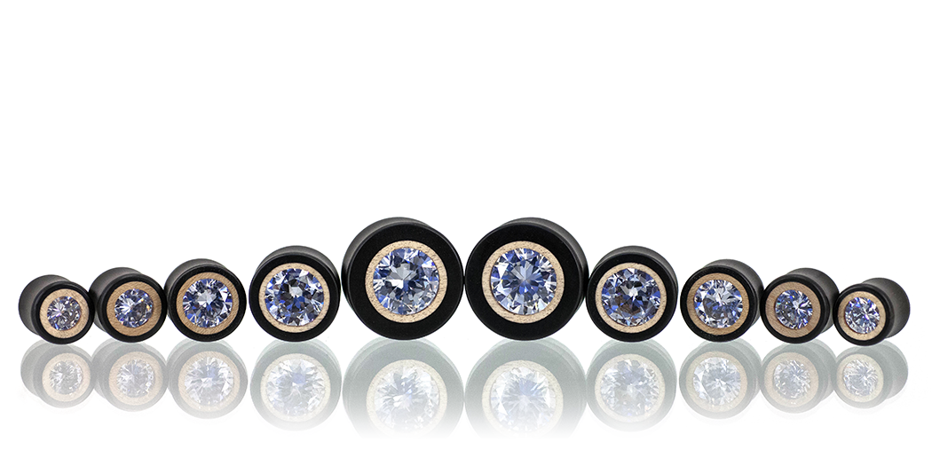 Clear CZ pair of ear gauges in Ebony wood with a Maple inlay. 