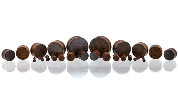 Ear gauges, wood plug made in Granadillo wood. Gauge size spread.
