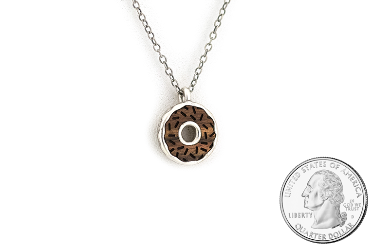 Doughnut pendant, cast in Sterling Silver with Chechen frosting and etched sprinkles. Size scale.