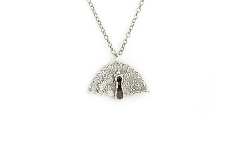 Peacock pendant made in sterling silver with blue mahoe wood inlay.