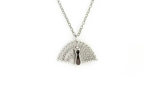Peacock pendant made in sterling silver with blue mahoe wood inlay.