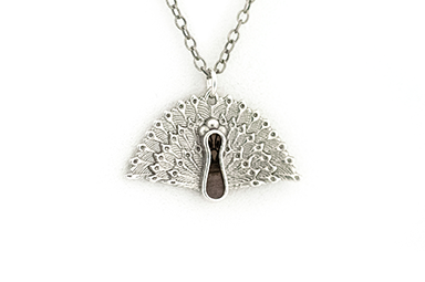 Peacock pendant made in sterling silver with blue mahoe wood inlay.